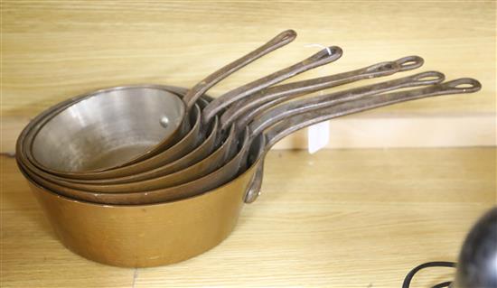 A set of six graduated copper saucepans